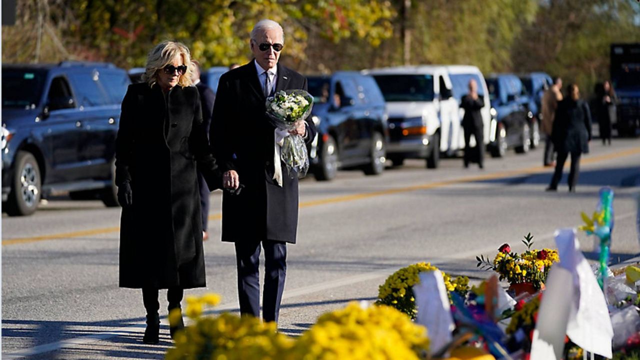 President Joe Biden and first lady Jill Biden arrive at Schemengees Bar and Grille, one of the sites of last week's mass shooting, to lay a bouquet of flowers Friday, Nov. 3, in Lewiston, Maine. (Associated Press/Evan Vucci)